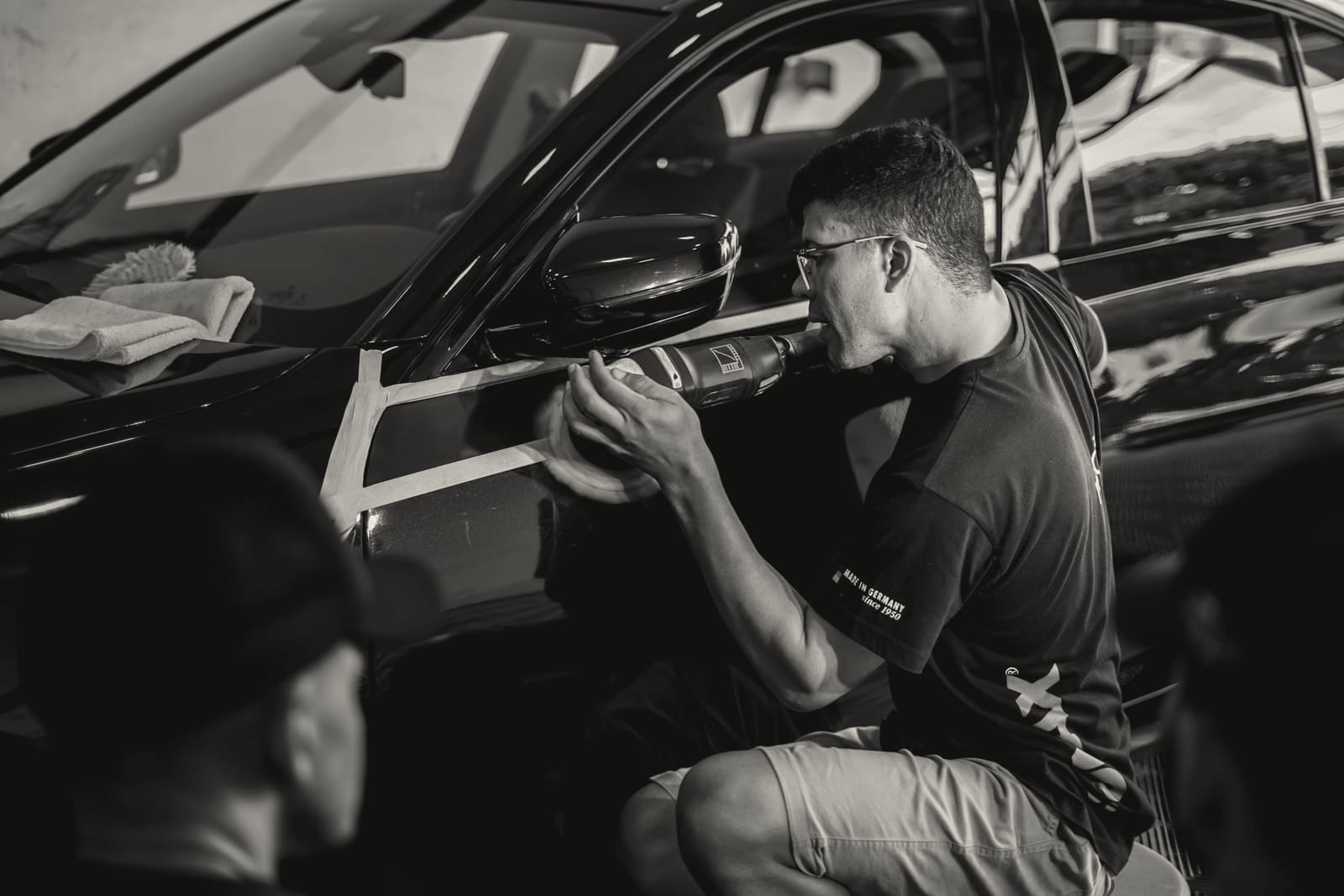 Edward working on dark paint during a detail